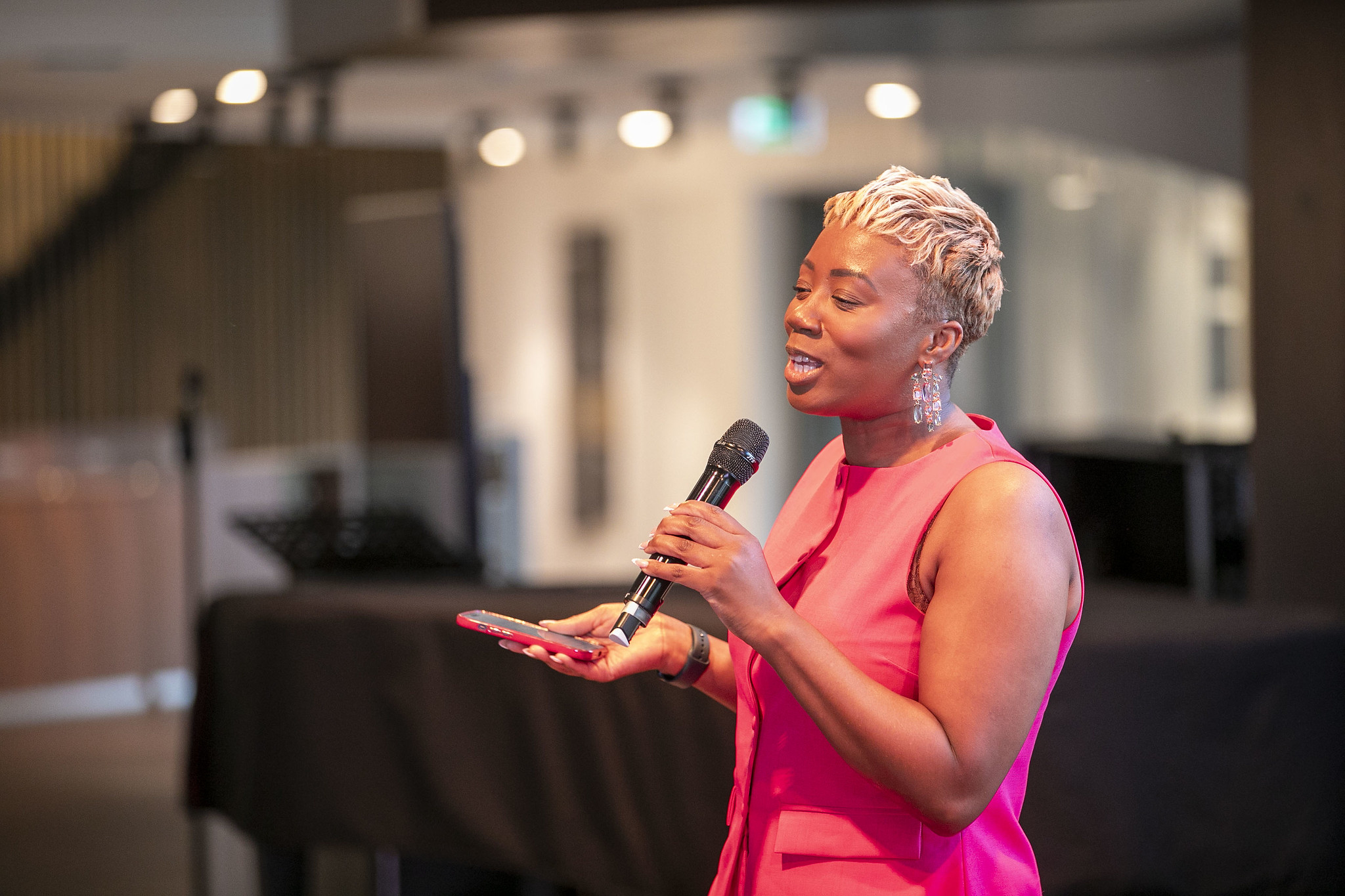 Justice Williams speaking to an audience with a handheld microphone
